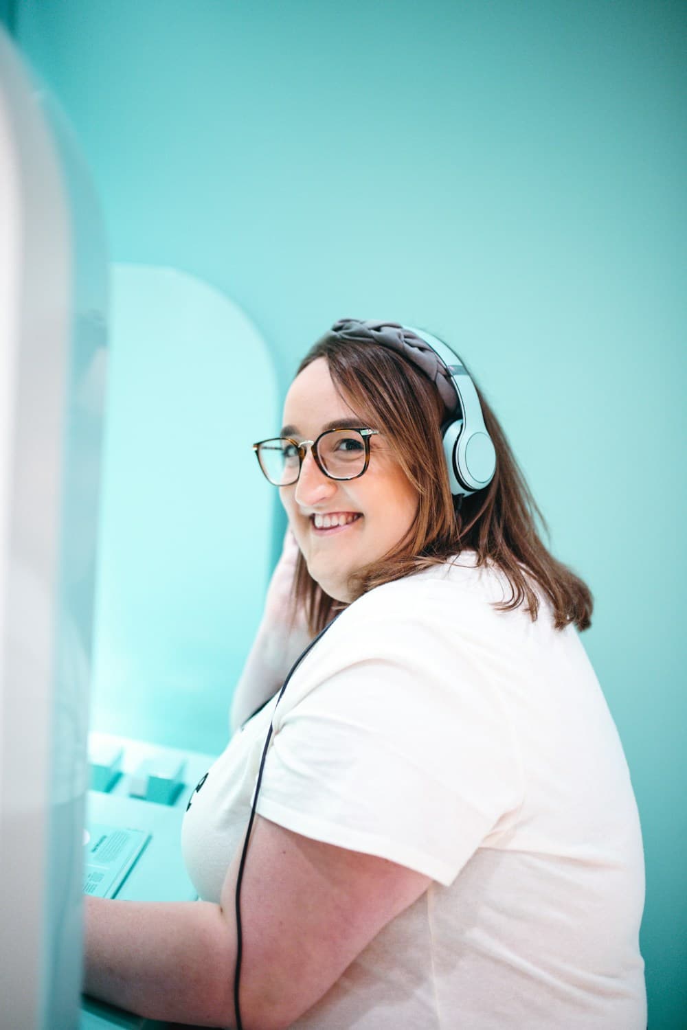 A smiling support worker wearing a headset