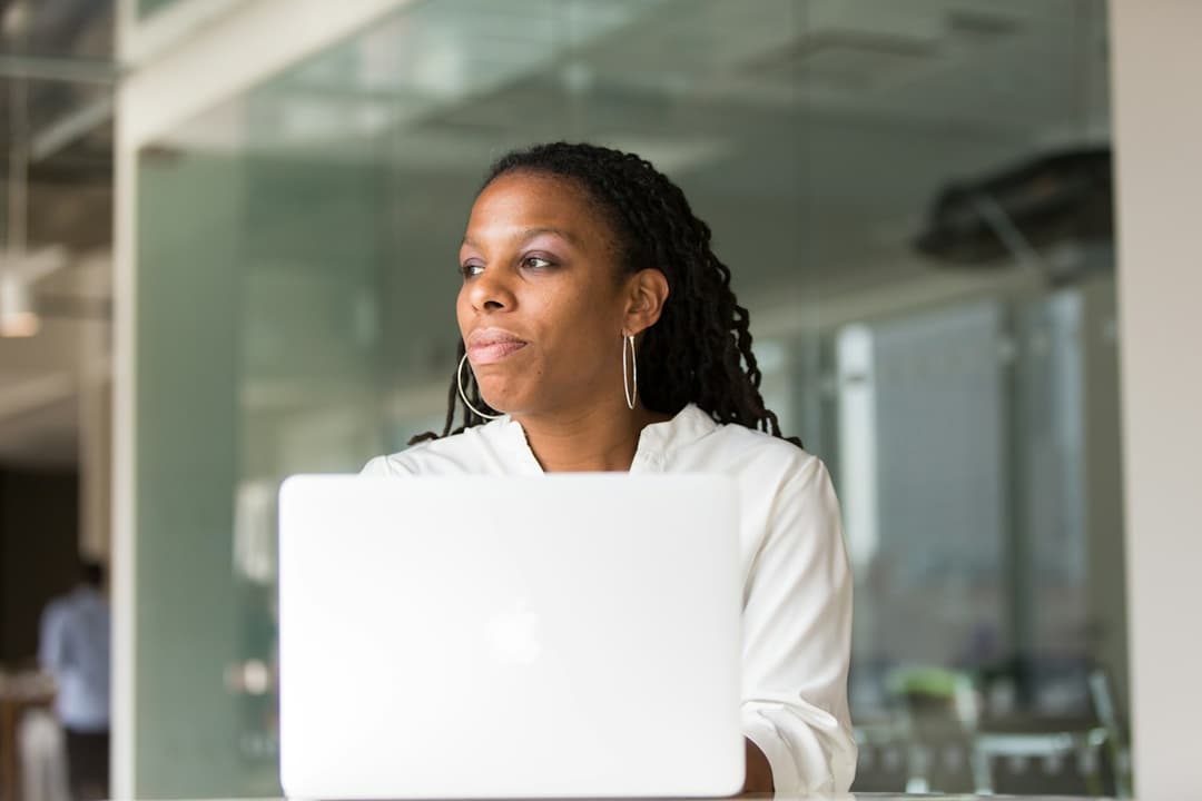 A woman working thoughtfully on her laptop